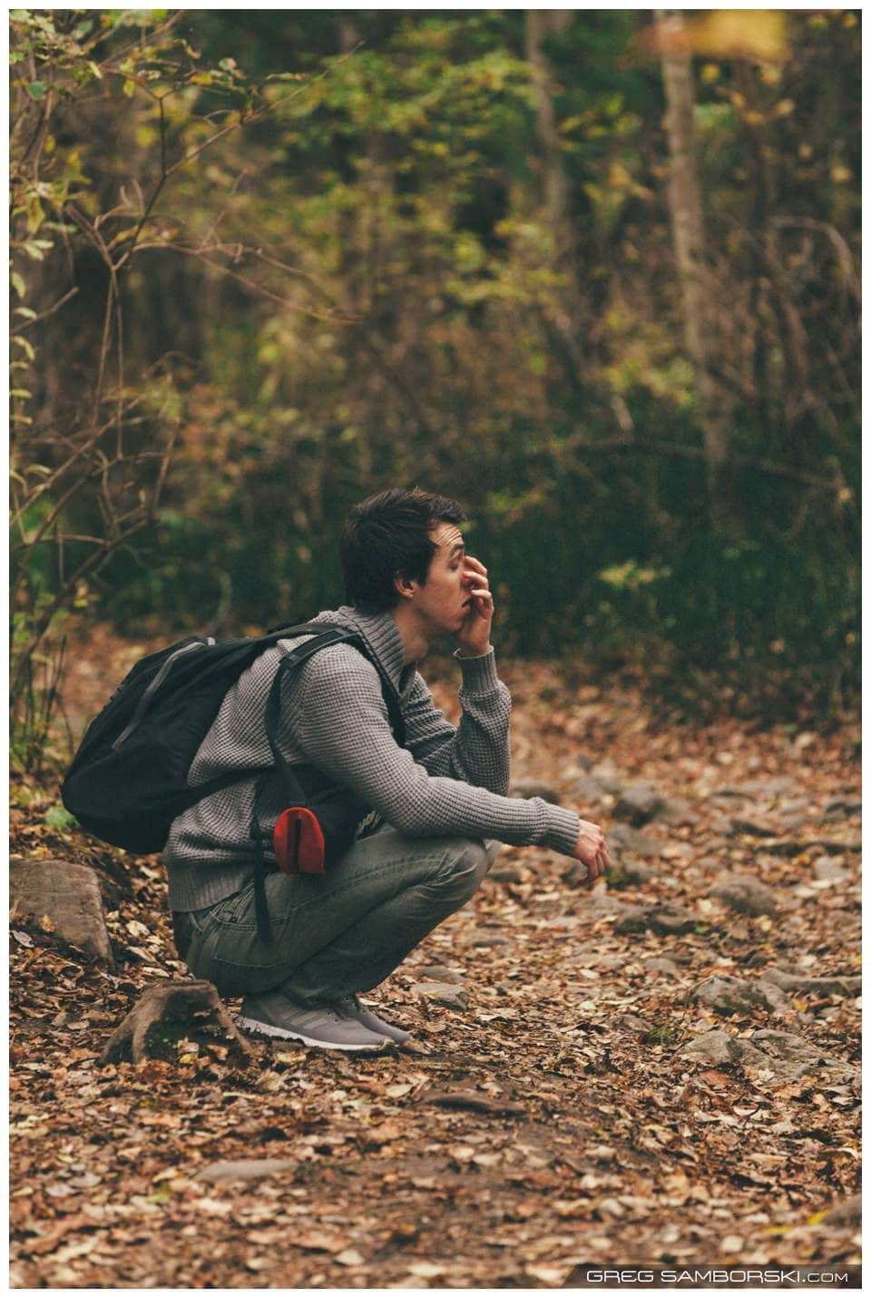 Guy Squating in Forrest